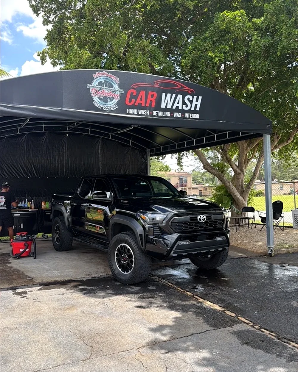 Black lifted Toyota Tacoma TRD Pro freshly detailed under Michael's Detailing Car Wash canopy at 1353 NW 79th St